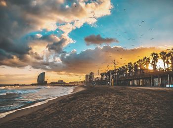 Scenic view of beach against sky during sunset