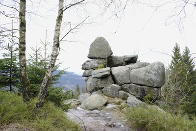 Rocks on landscape against sky