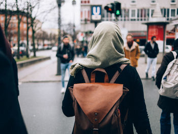 Woman standing on city street