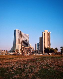 View of built structures against clear blue sky