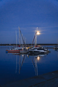 Boats moored at harbor