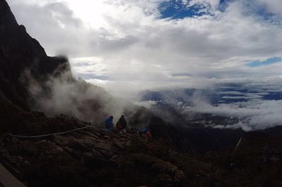 Panoramic view of people on landscape against sky