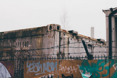 Graffiti on wall of building against clear sky