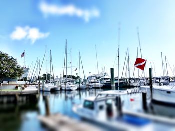 Boats moored at shore against sky