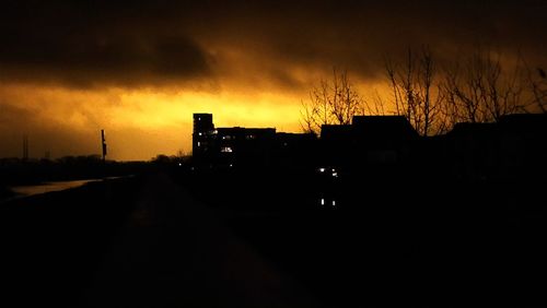 Silhouette of road against dramatic sky
