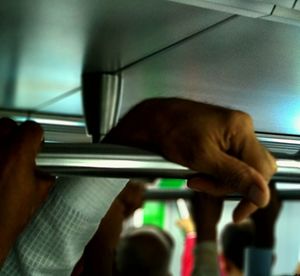 Close-up of man hand on train