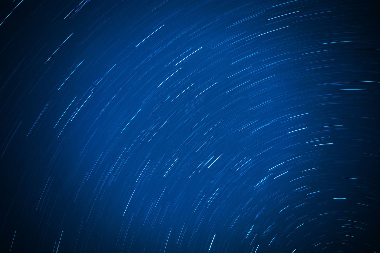 LOW ANGLE VIEW OF STAR TRAILS IN SKY