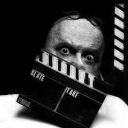 Portrait of man with arms raised