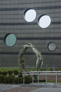 Sculpture in front of built structure