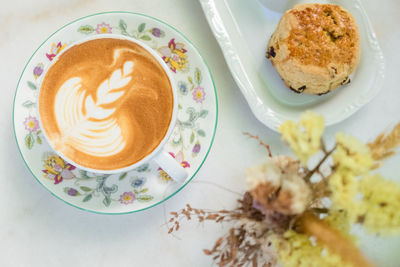 High angle view of cappuccino served on table