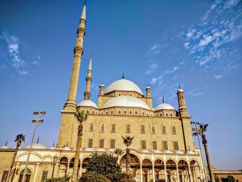 Low angle view of mosque against blue sky