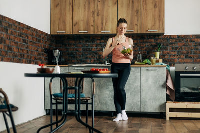 Portrait of an attractive woman holding a salad bowl and looking at the camera. beautiful athletic 