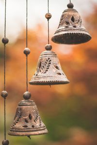 Close-up of bells hanging outdoors