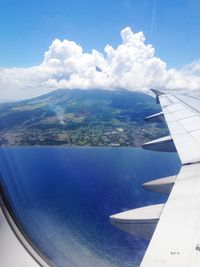 Cropped image of airplane flying over sea