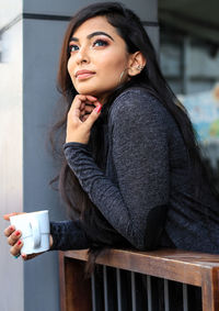 Portrait of woman with coffee cup