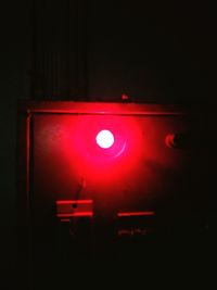 Close-up of illuminated lighting equipment in dark room