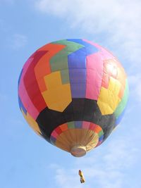 Low angle view of hot air balloons flying against sky