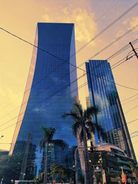 Low angle view of modern buildings against sky during sunset