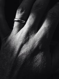 Cropped hand on man with wedding ring