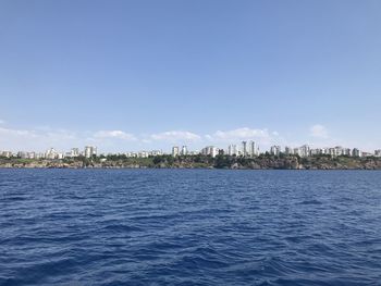 Scenic view of sea and buildings against sky