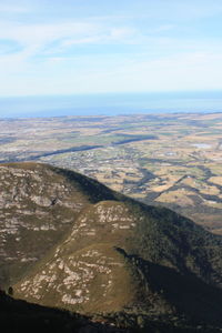 High angle view of land and sea against sky