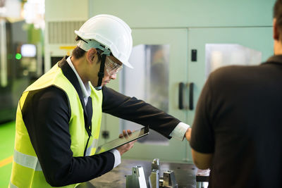 Side view of man working in cafe