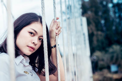 Portrait of young woman holding rope