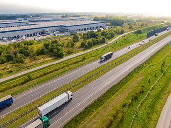 Aerial view of goods warehouse. logistics center in industrial city zone from above. aerial trucks 