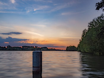 Scenic view of lake against sky during sunset