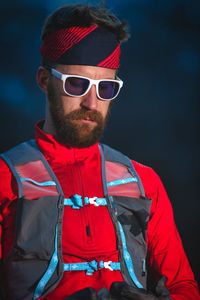 Close-up of young man wearing sunglasses standing outdoors