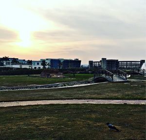 Buildings in city against sky during sunset