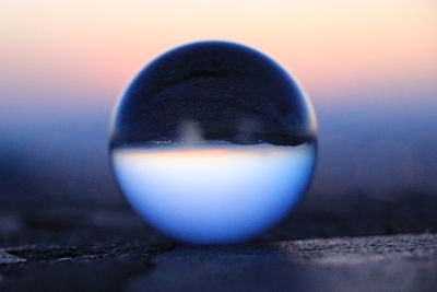 Close-up of crystal ball on glass