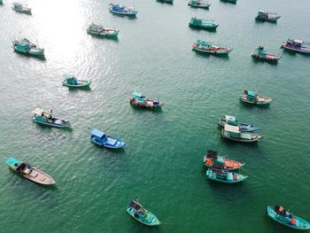 High angle view of people on boats sailing in sea