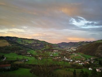 Scenic view of townscape against sky during sunset