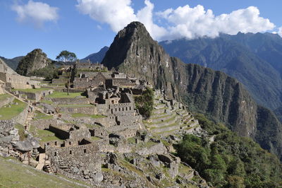 Castle on mountain against cloudy sky