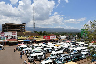 Traffic on road by buildings against sky