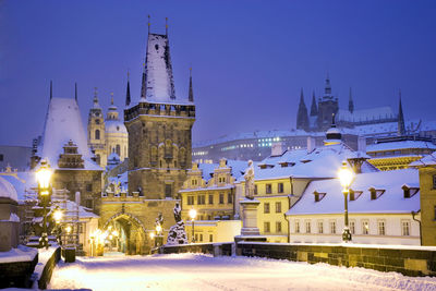 Illuminated church in city at night during winter