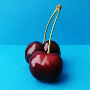 Close-up of apple on blue table