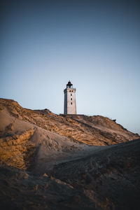 Low angle view of lighthouse against clear blue sky