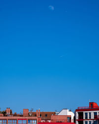 Low angle view of buildings against blue sky