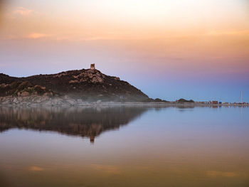 Scenic view of lake against sky during sunset