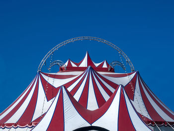 Low angle view of umbrella against clear blue sky