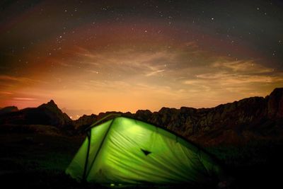 Scenic view of mountains against sky at night
