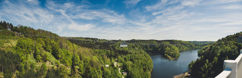 Panoramic view of river amidst trees against sky