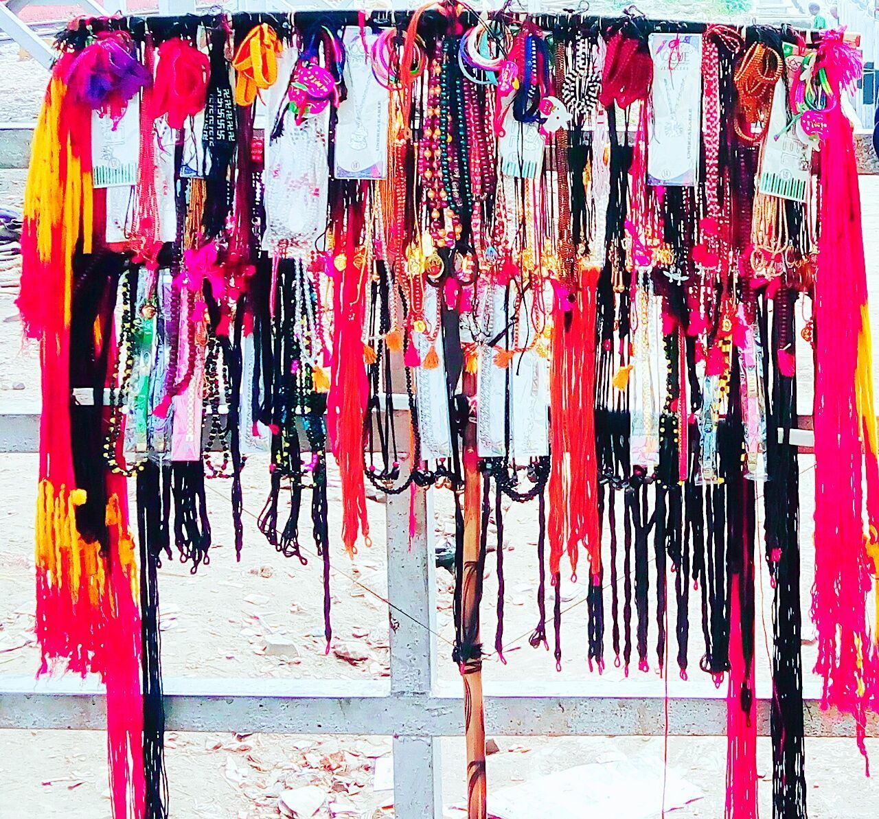MULTI COLORED DECORATIONS HANGING AT MARKET STALL