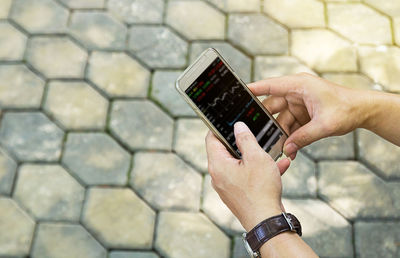 Midsection of person holding umbrella