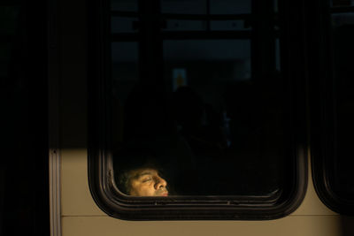 Man looking through window