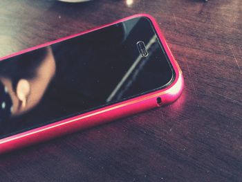 High angle view of smart phone on table