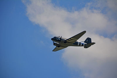 Low angle view of airplane flying against sky