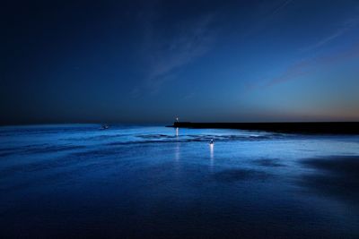 Scenic view of sea against blue sky